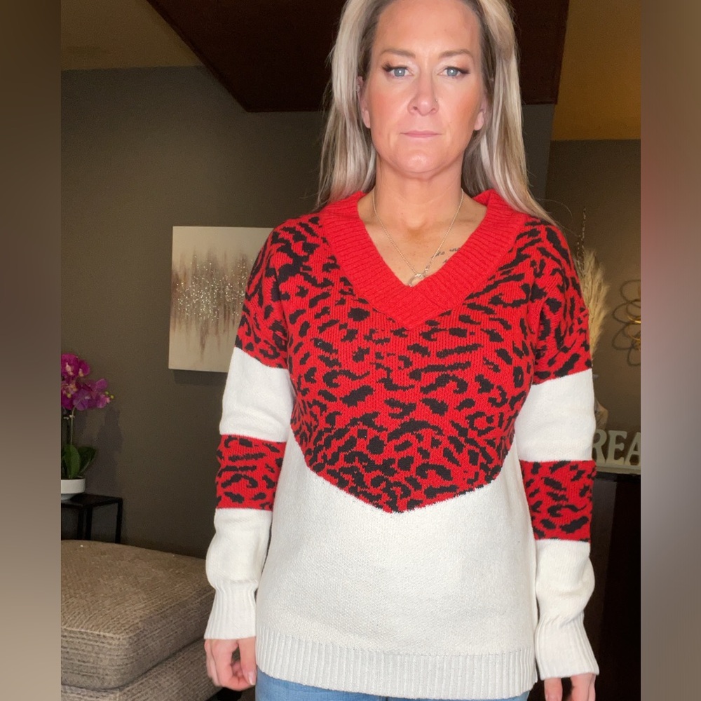 White, red and black cheetah sweater, size large.